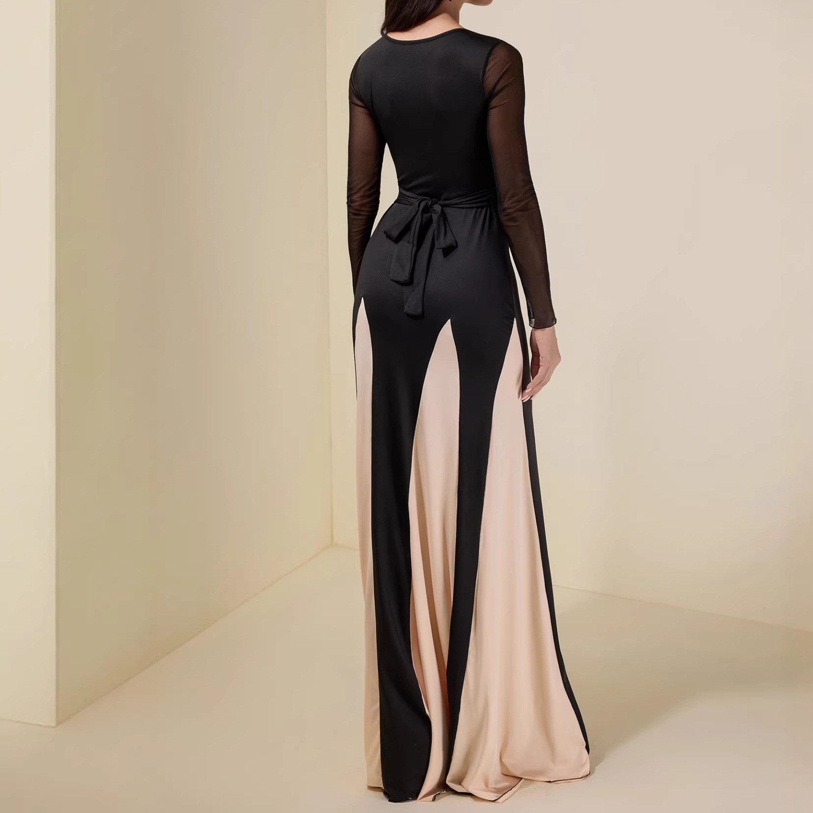 A long-sleeved women's dress with a fitted and elegant design, featuring a seamless and colorful blend