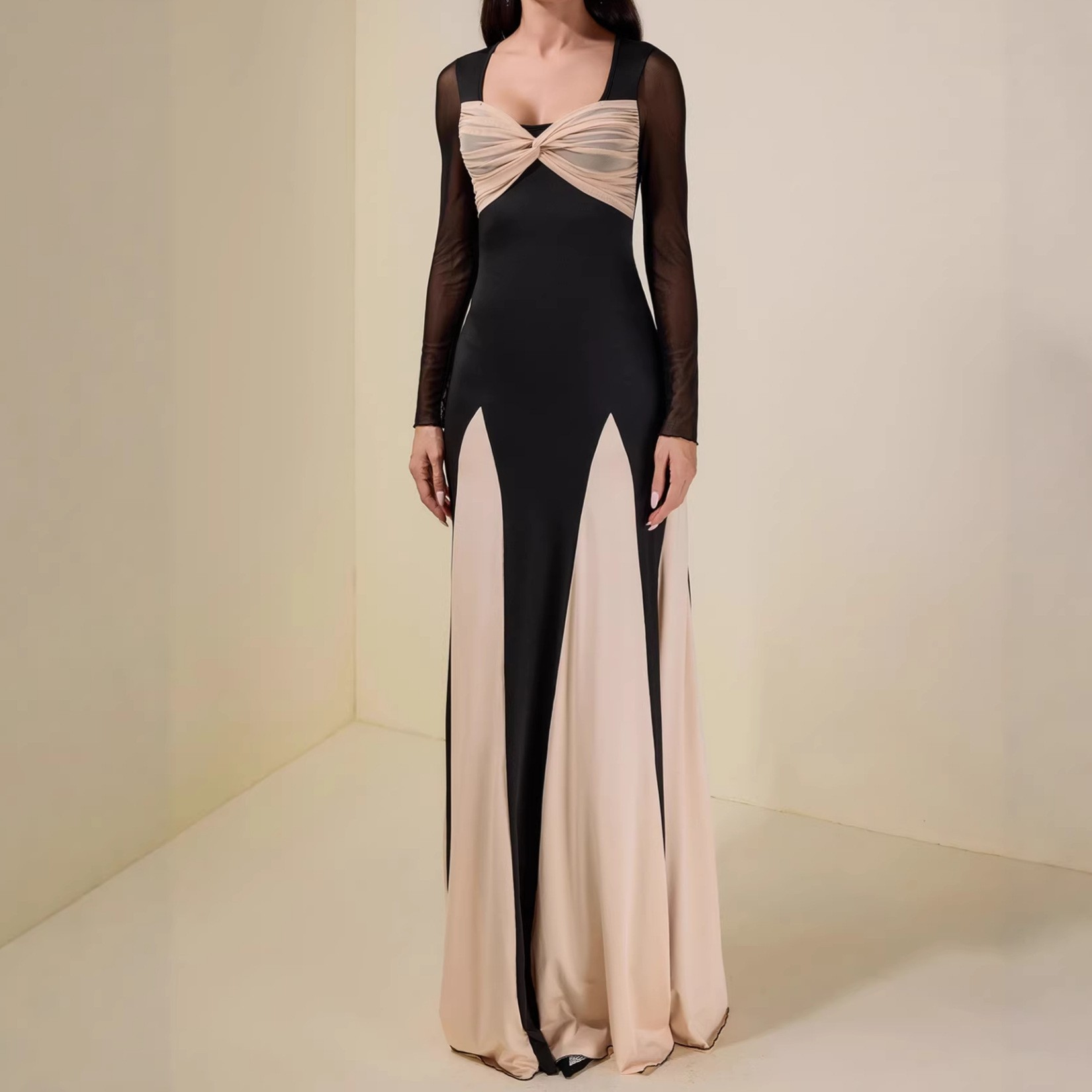 A long-sleeved women's dress with a fitted and elegant design, featuring a seamless and colorful blend