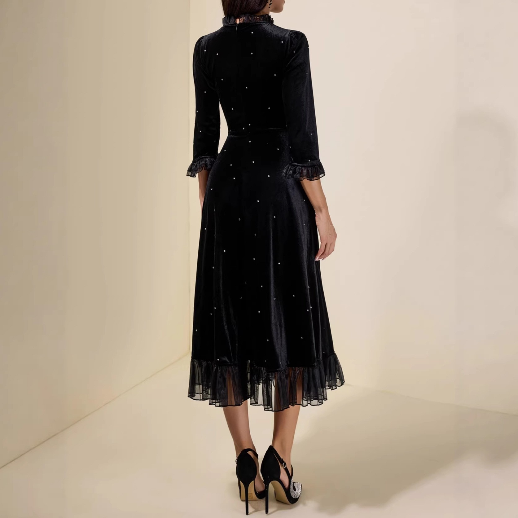 Black sequined chiffon halter-neck dress with three-quarter sleeves and frilled edges