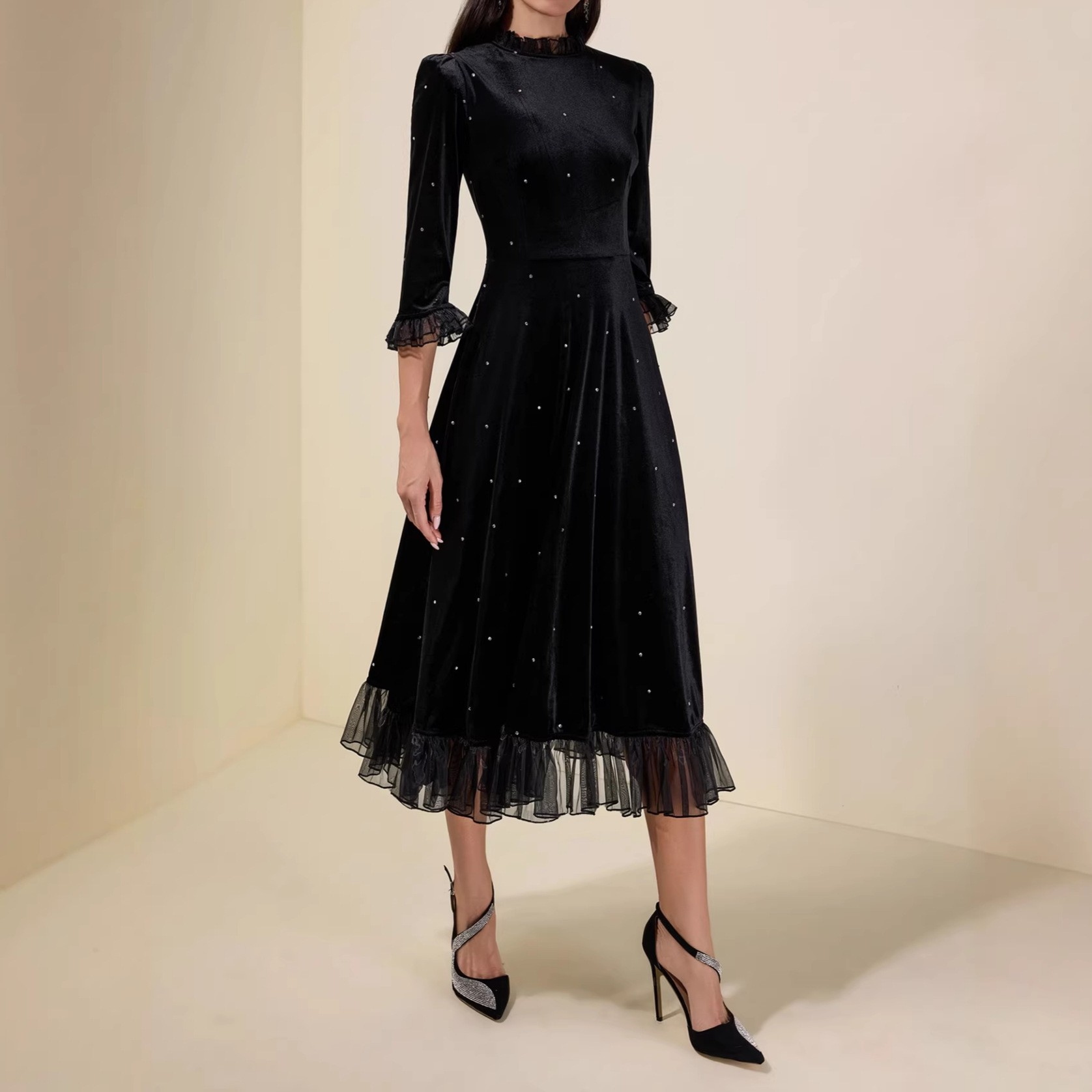 Black sequined chiffon halter-neck dress with three-quarter sleeves and frilled edges