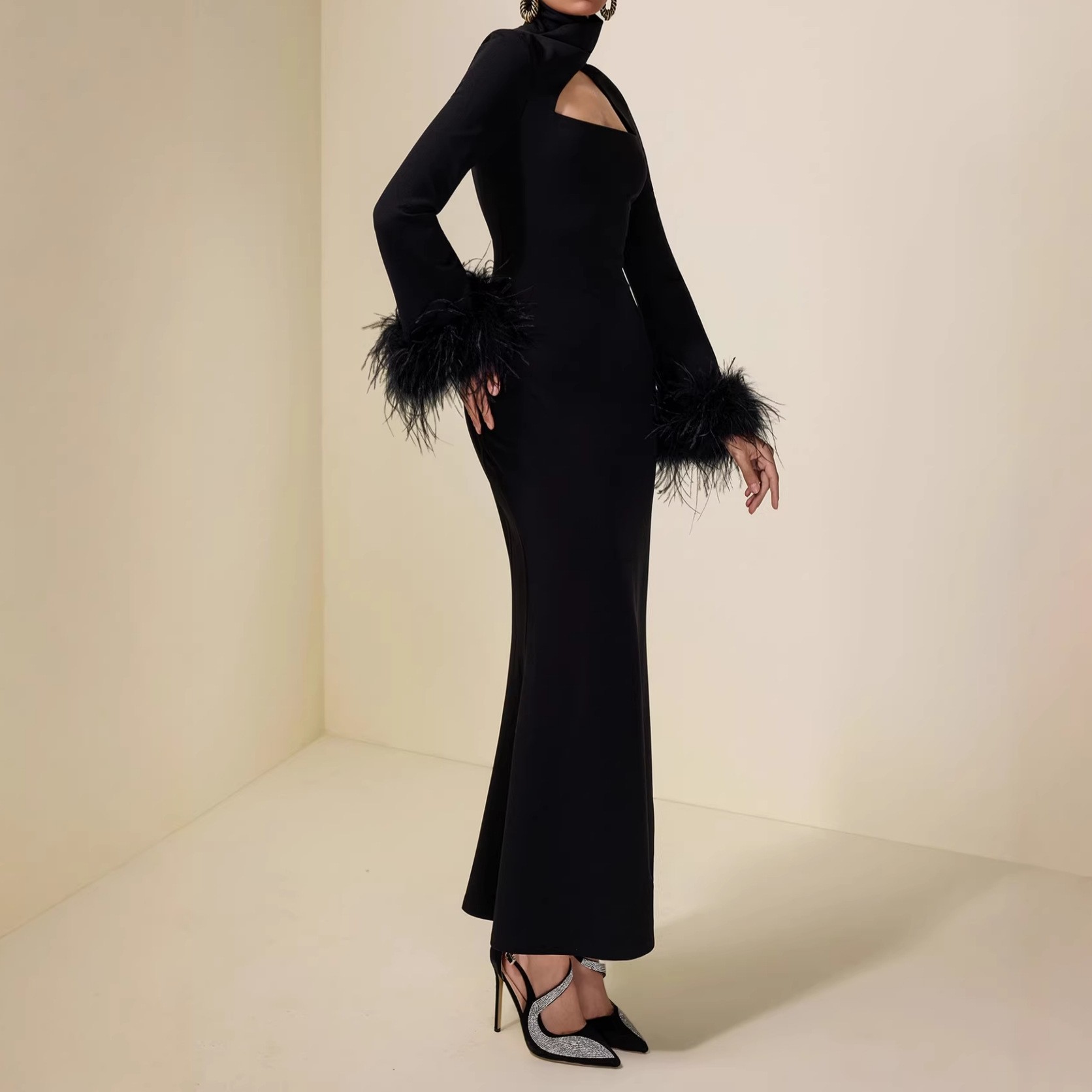 High-necked, fitted bodice, feathered cuffs, pure black, full-skirted, long dress with a flattering silhouette